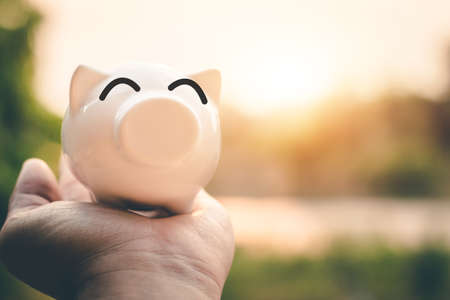 Saving money in pig bank for future use, Concept saving money for the future.の写真素材