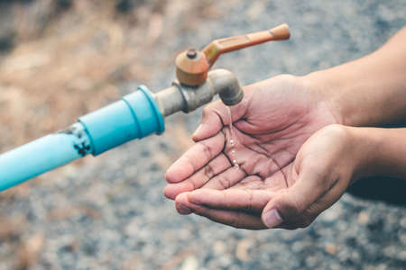 Men hand are waiting to drink water in the water shortage.の写真素材