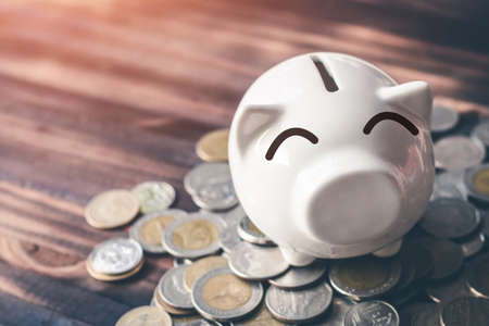 Saving money in pig bank for future use, Concept saving money for the future.の写真素材