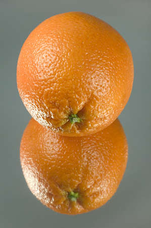 Orange reflected on a piece of mirror cardの写真素材