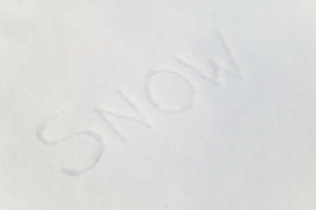 The word 'Snow' written in fresh snow, suitable for backgroundsの写真素材