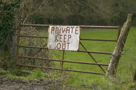 Sign on an old metal gate into a field 'Private Keep Out'の写真素材