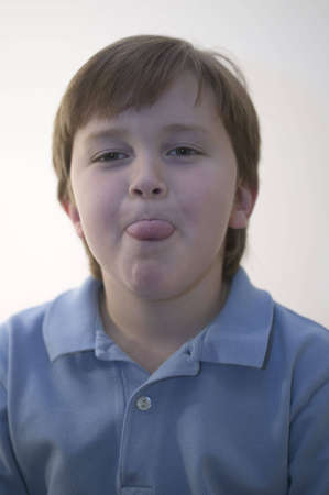 A young boy sticking his tongue outの写真素材