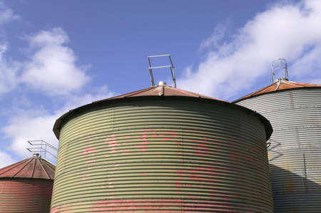 Grain drying silo's against a blue skyの写真素材