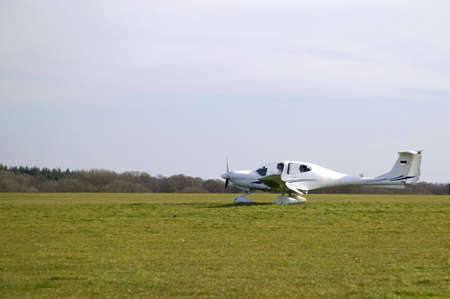 Light aircraft about to take off on a grass airfieldの写真素材