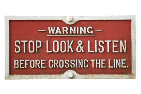 Old railway warning sign, isolated on white.の写真素材