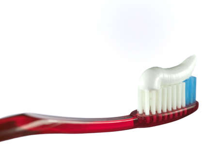 Red toothbrush and paste, isolated on white.の写真素材