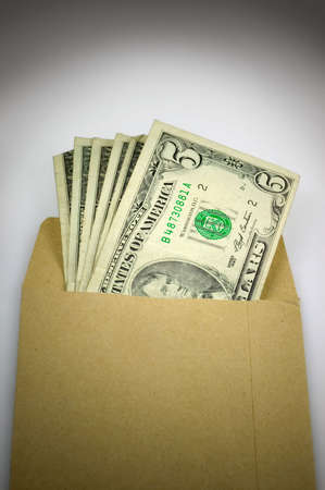 Brown envelope full of cash, bribery and corruption.