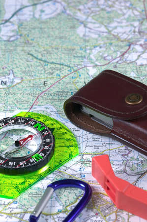 Compass and accessories on a map background.