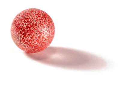 Orange marble with shadow isolated on whiteの写真素材