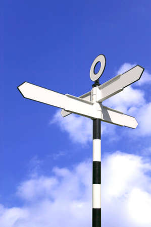 Blank road sign against a bright blue sky.の写真素材