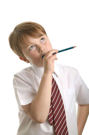 School boy in deep thought, isolated on white.の写真素材
