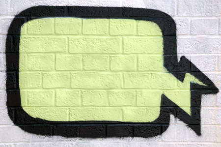 Graffiti thought bubble sprayed on a brick wall, enter your own text.のeditorial素材
