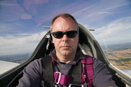 Man inside the cockpit of a glider at 3000 feet.の写真素材