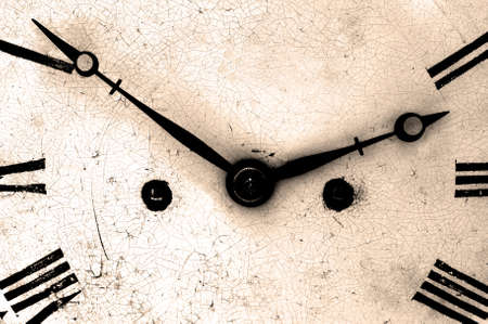 Close up of an antique clock face, dark and grainy sepia toned.の写真素材