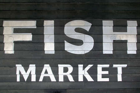 Fish Market painted on the side of a wooden building.の写真素材