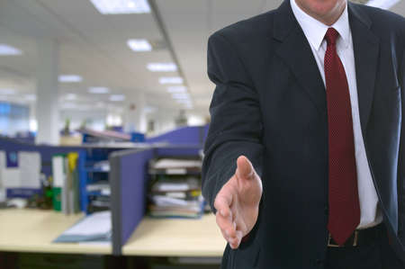 Man offering his hand to welcome you to the office.の写真素材