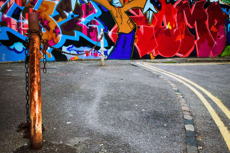 Inner city scene of urban graffiti spray painted on a wall.の写真素材