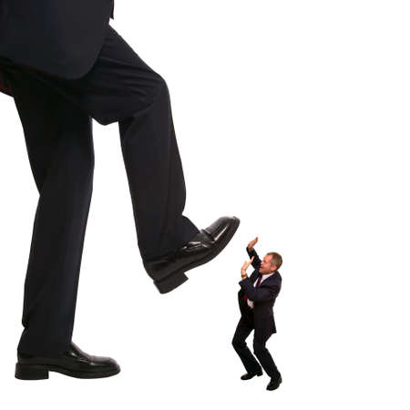 Concept image of an employee about to be stepped on by his manager.の写真素材