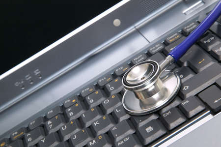 Computer health image of a stethoscope on a laptop keyboard.