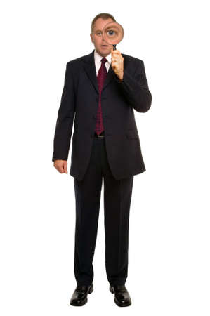 Businessman using a magnifying glass for a close inspection.の写真素材