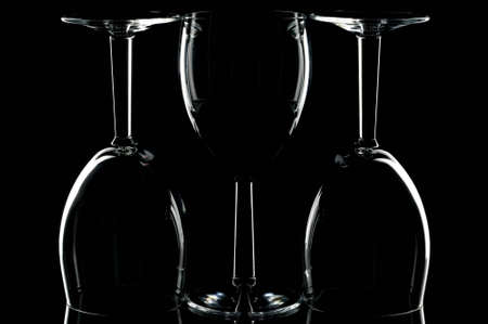Low key shot of three wine glasses against black.の写真素材
