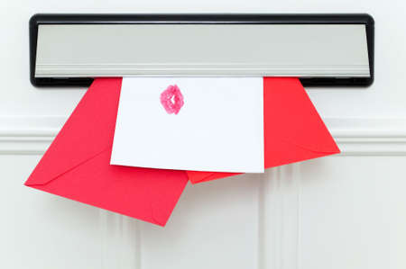 Valentine's cards coming through the letterbox, one sealed with a kiss.