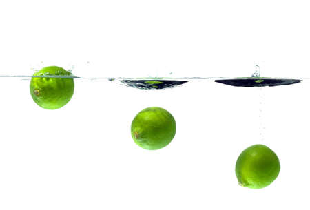 An image showing a Lime's progress as it's dropped into water. Slight motion blur.の写真素材