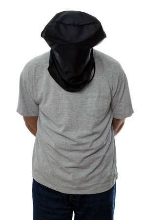 Man with a black hood over his head and his hands tied behind his back.の写真素材