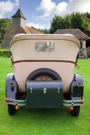 A wedding car parked outside a church. Space on the trunk to add your own message such as Just Married.の写真素材