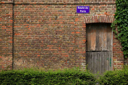 Road sign for Route de Paris on the side of an old French buildingの写真素材