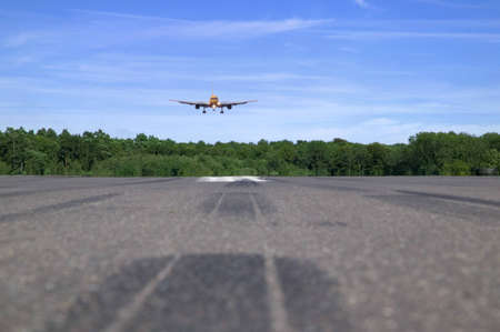 Jumbo jet coming into land, low perspective focus is on the plane foreground blurred.の写真素材