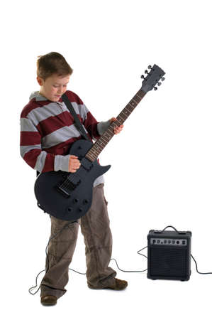 A boy playing a matt black electric guitar with amplifier, isolated on a white background.の写真素材