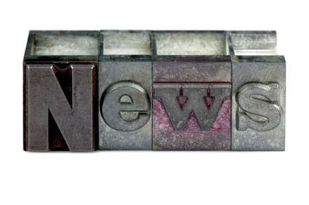 The word News in old letterpress printing blocks isolated on a white background.の写真素材