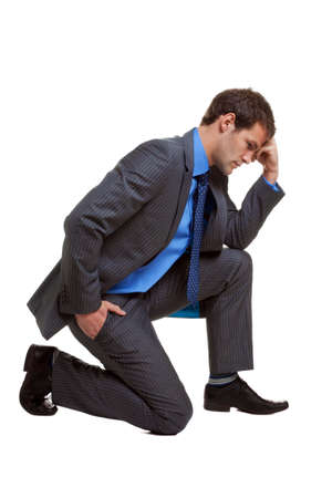 Image of a businessman in a pose known as The Thinker, isolated on white background with slight shadow at contact points.の写真素材