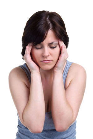 Woman with a migrane headache holding her hands against the side of her head, isolated on white background.の写真素材