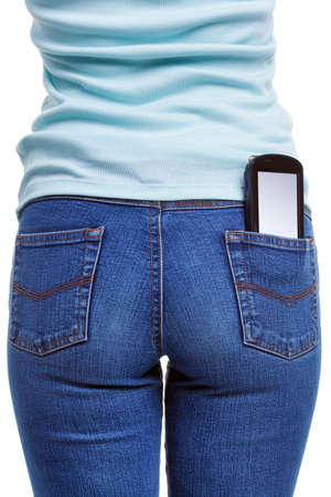 A smartphone in the rear pocket of a womans jeans