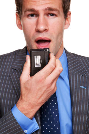 Businessman speaking into a dictation recorderの写真素材