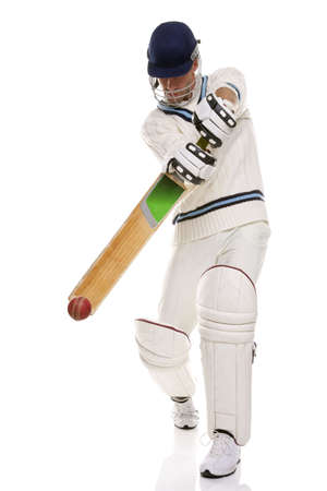 Cricketer playing a shot, studio shot on white background.