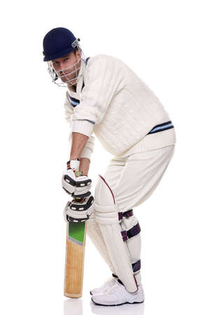 Cricketer getting ready to face the ball, studio shot on white background.