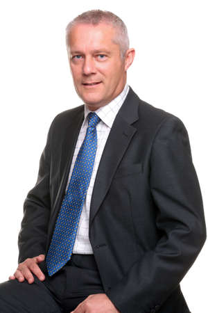 Portrait of a mature businessman wearing a gray suit with blue tie, isolated on a white background.の写真素材