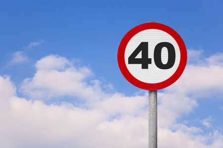 A round roadsign with the number 40 on it against a blue cloudy sky.の写真素材