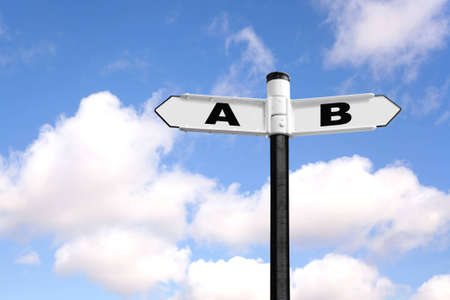 From A to B signpost against a blue cloudy sky. Good image for time management related themes.