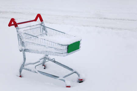 An abandoned shopping trolley in the snowの写真素材