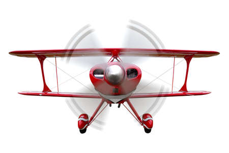 A red biplane, front view with propeller in motion, isolated on a white background.の写真素材
