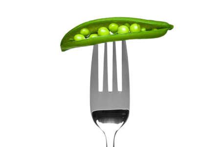 Photo of an open pea pod on a fork isolated on a white background, part of a series.の写真素材