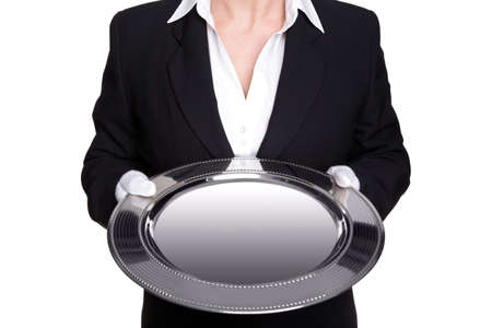 a female butler holding a silver tray, isolated against a white background. Good image for product placement.の写真素材