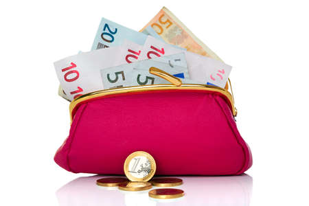 a purse full of cash Euro banknotes and coins in front, studio shot on a white background.の写真素材