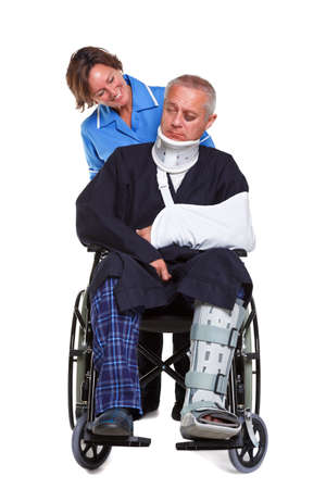 Photo of an injured man in a wheelchair with a female nurse pushing him, isolated on a white background.の写真素材