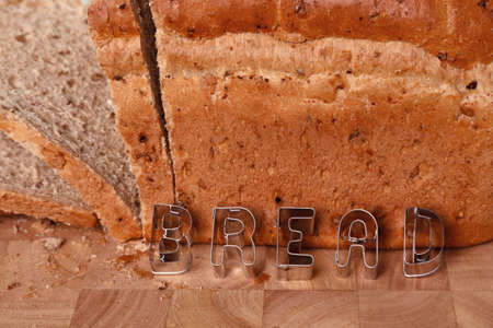 Loaf of brown bread with the word in in pastry letters.の写真素材